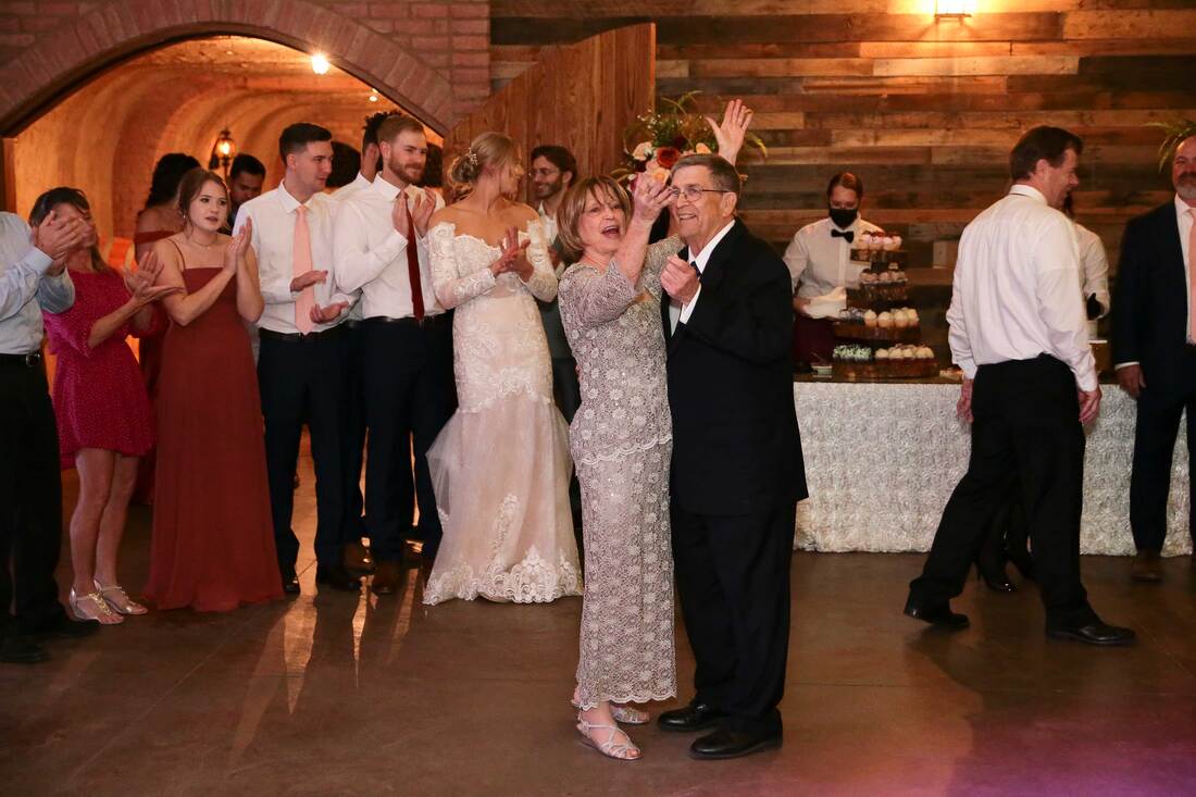 candid photo of bride and groom with grandparents doing the anniversary dance in OKC