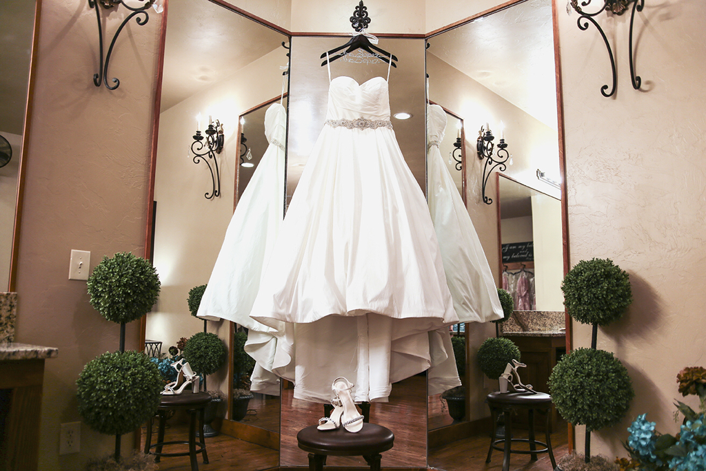 Wedding dress from David’s bridal with pockets, hanging up in the bridal suite at the springs in Edmond, Oklahoma 