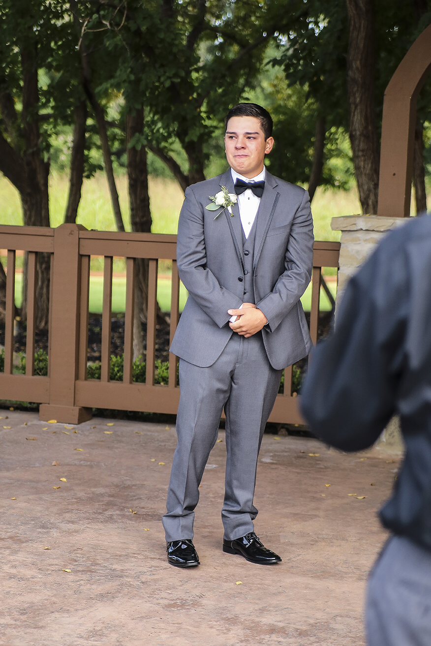 Groom crying when he sees the bride walking down the isle, candid wedding photo