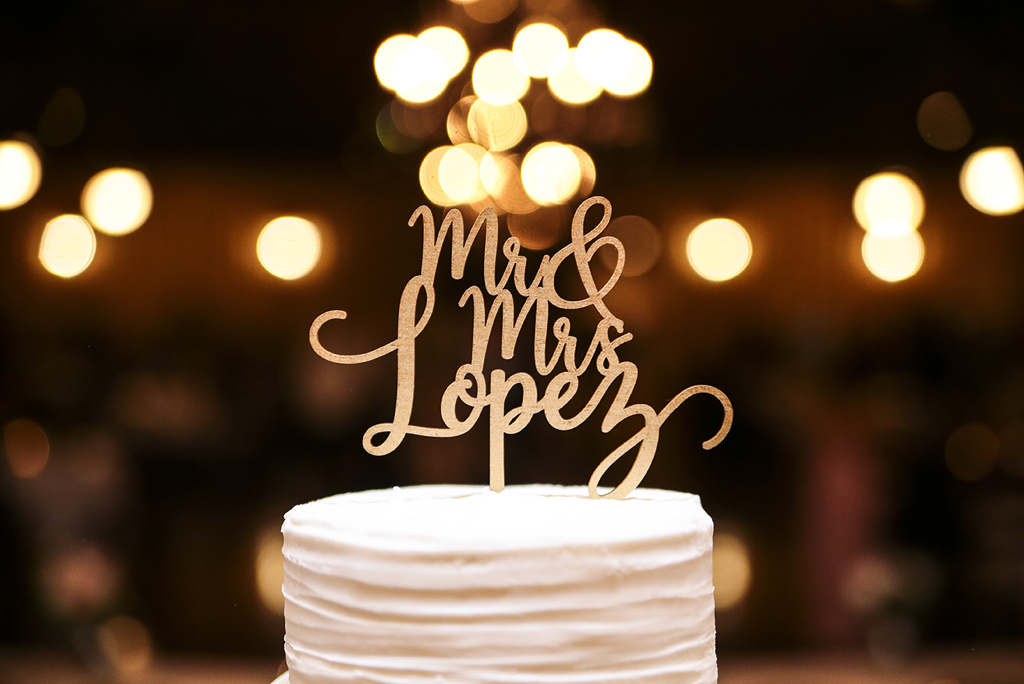Custom cake topper with bokeh lights in the background on a wedding cake at the springs in Edmond, Oklahoma 
